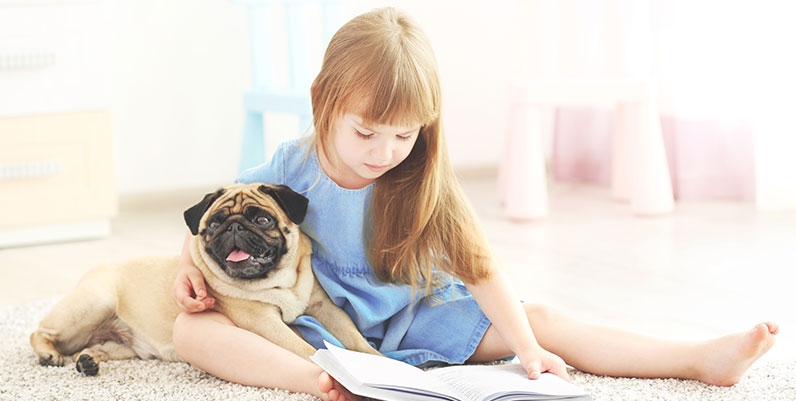 Sit! Stay! Read! girl reading with a dog