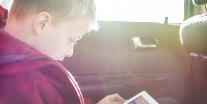 French eBooks Young boy reading from a tablet