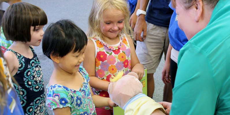 Kids Programs Group of children interacting with a puppet