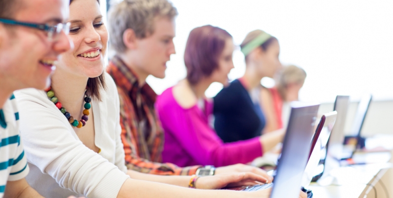 Teen Programs Group of teens sitting at computers