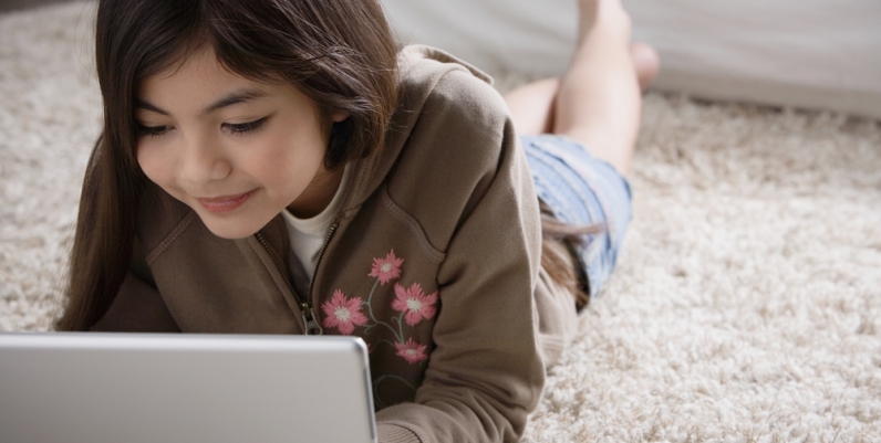 Tweens Tween girl using laptop