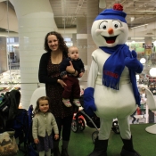 A family poses for a picture with Chimo the snowman
