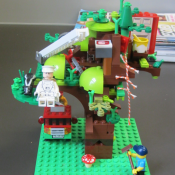 a lego man stuck in a lego tree