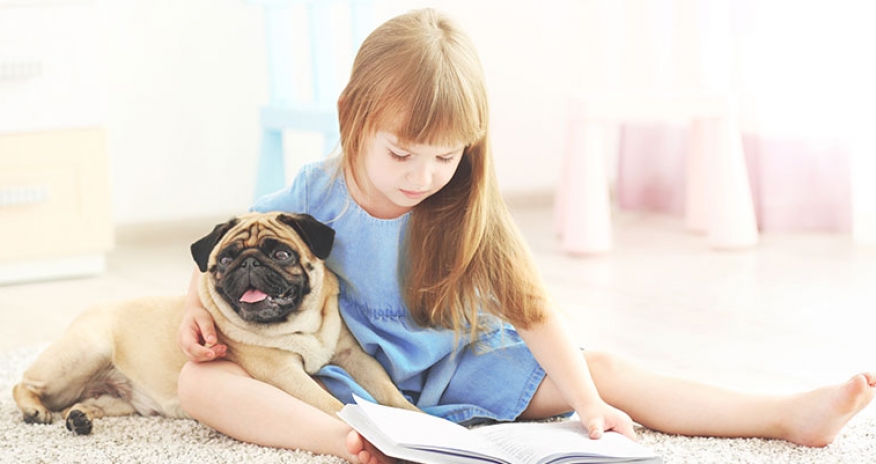 Sit! Stay! Read! girl reading with a dog